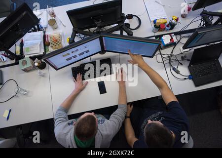 top view of software developers writing programming code on computer Stock Photo