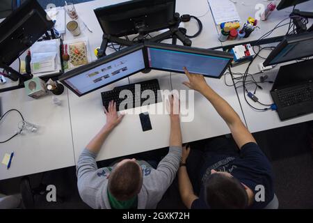 top view of software developers writing programming code on computer Stock Photo