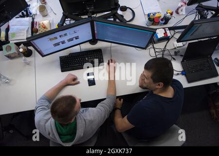 top view of software developers writing programming code on computer Stock Photo