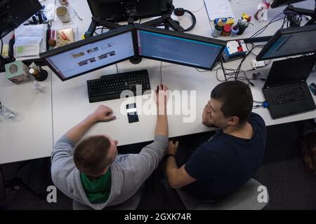 top view of software developers writing programming code on computer Stock Photo