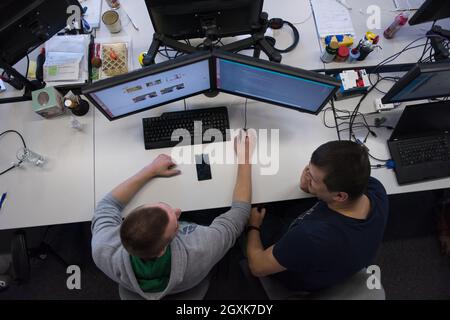top view of software developers writing programming code on computer Stock Photo