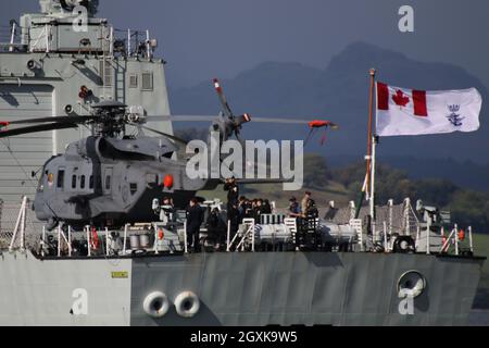 148826, a Sikorsky CH-148 Cyclone helicopter operated by the Royal Canadian Air Force, on board HMCS Fredericton (FFH-337), a Halifax-class (or City-class) frigate operated by the Royal Canadian Navy. The vessel is seen passing Greenock on the Firth of Clyde, as she heads out to participate in the military exercises Dynamic Mariner 2021 and Joint Warrior 21-2. Stock Photo