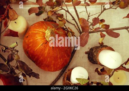 Stylish thanksgiving autumn table decor with pumpkin and dried branches Stock Photo