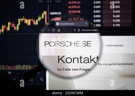 Porsche SE company logo on a website with blurry stock market developments in the background, seen on a computer screen through a magnifying glass Stock Photo