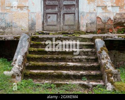 Destroyed porch and steps of the old mansion. Ruined entrance of the former manor house Stock Photo