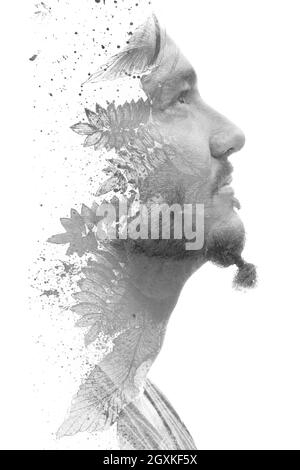 Paintography. Black and white detailed painting of plants combined with a profile portrait of a stylish young man Stock Photo