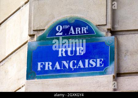 Traditional street name plate of the 2nd arrondissement of Paris on which reads 'French Street' written in French Stock Photo