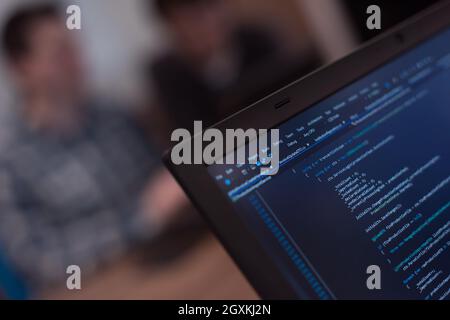 Software development  Software source code  Programming code  Writing programming code on laptop Stock Photo
