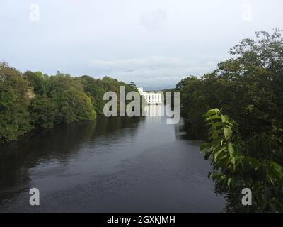 View from Tongland Bridge near Kirkcudbright, Scotland. It was designed by Thomas Telford (1757-1834). Nearby is Tongland Hydro-electric power station (seen in background). The bridge was the first major one in Scotland at the time of its construction. Built in 1804-8, it replaced an older bridge upstream and was the first bridge to have weight-saving hollow ribbed spandrels instead of a solid masonry arch. Though beautiful in construction, its full grandeur can only be appreciated by walkers on the nearby riverside footpath as cannot be seen in its entirety from the road over it. Stock Photo