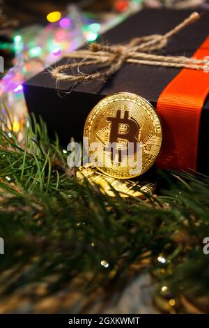 Christmas bitcoin garland gifts and fir branches Stock Photo