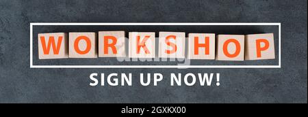 The word workshop is standing on wooden cubes, sign up now bottom, chalkboard background Stock Photo