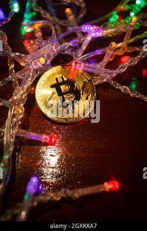Christmas bitcoin garland gifts and fir branches Stock Photo