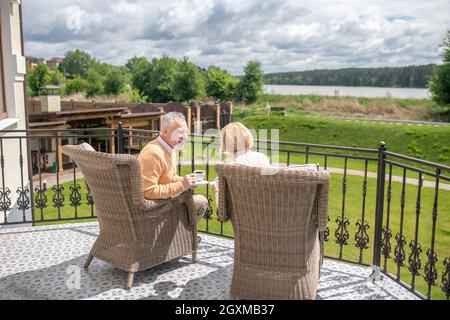 Two Wicker Arm Chairs On Front Patio Stock Photo - Alamy
