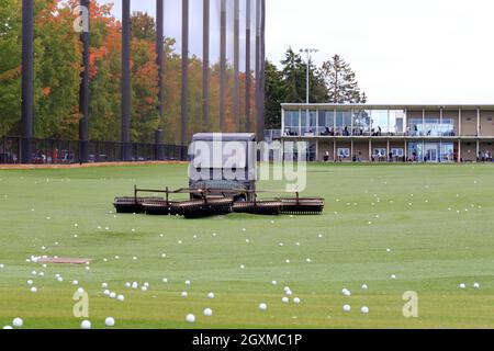 Driving Ranges Seattle A golf cart equipped with a golf ball retriever at a driving range in ...