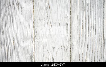 Wood texture background, top view of empty light wooden table. Vertical white rough planks of fence or wall for rustic wallpaper. Painted old barn boa Stock Photo