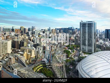 tokyo, japan - may 03 2021: Bird's eye view of the Tokyo Dome stadium called The Big Egg aside the steel roller coaster Thunder Dolphin overlooking th Stock Photo