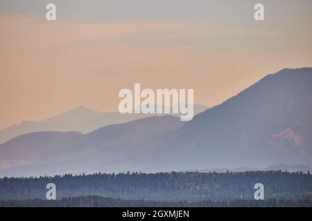 Foggy mountain layers on sunset Stock Photo