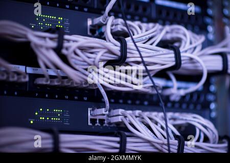 optical cables connected to main server in the server room at data center Stock Photo