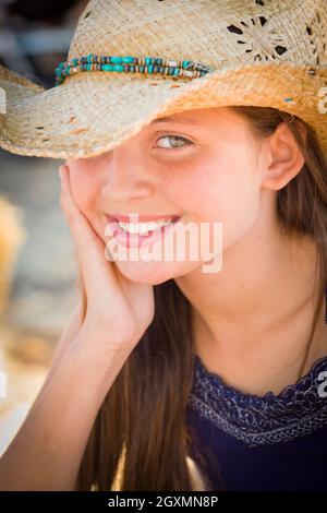 Preteen Girl Portrait Wearing Cowboy Hat in Rustic Setting. Stock Photo