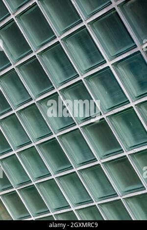 close-up of glass square bricks used for allowing light through a wall acting as a window. glass bricks, glass cubes, building materials. Stock Photo