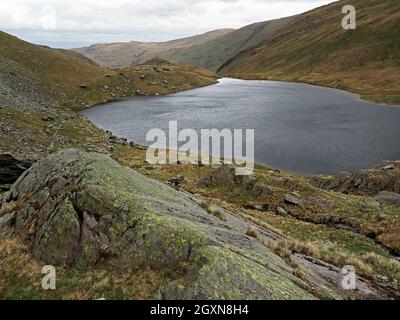 rocky lakeland landscape looking over Small Water above Haweswater (formed by damming Mardale) below Nan Bield pass, High Street Cumbria, England, UK Stock Photo