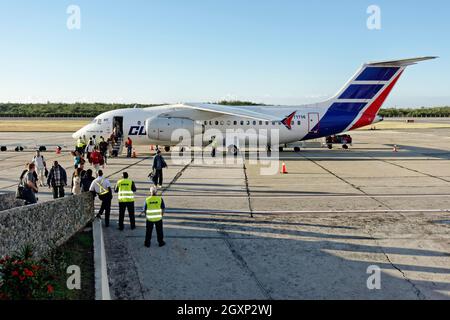 Passengers disembark Antonov An-158 regional jet, stretched version of An-148, Santiago de Cuba airport, Santiago de Cuba province, Caribbean, Cuba Stock Photo