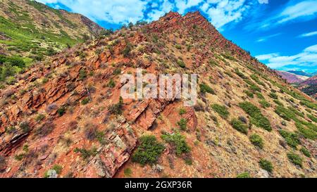 Mountains up close with large red rocks at angle Stock Photo