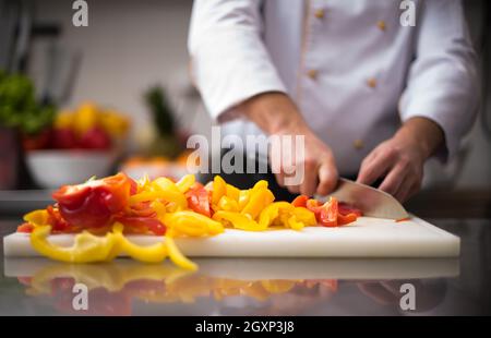 Chef cutting fresh and delicious vegetables for cooking or salad Stock Photo