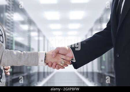 business man and woman handshake on successful  meeting at rack server room Stock Photo