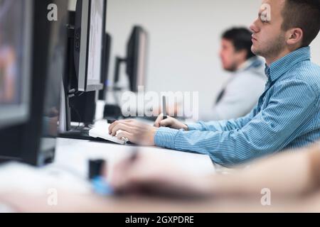 photo editors working with graphic tablet and pen on photographs in retouching studio Stock Photo
