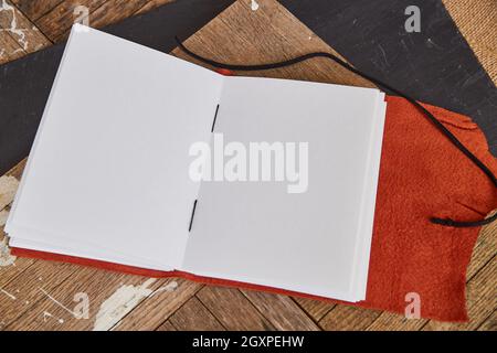 Orange Leather open blank sketch book on wood Stock Photo