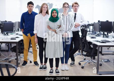portrait of young excited multiethnics business team of software developers standing and looking at camera at modern startup office Stock Photo