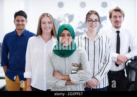 portrait of young excited multiethnics business team of software developers standing and looking at camera at modern startup office Stock Photo