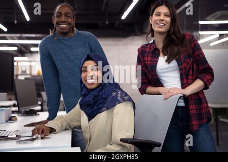 young multiethnics business team of software developers working together using laptop computer while writing programming code at modern startup office Stock Photo