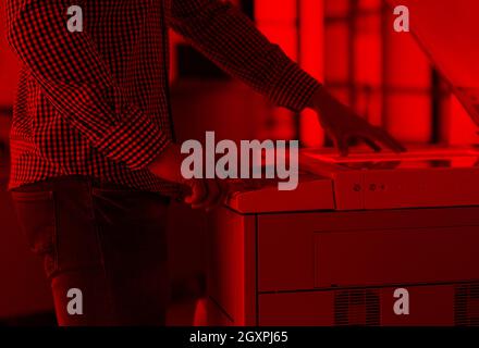 young business man copy documents on copy machine at modern startup office interior, casual clothes Stock Photo