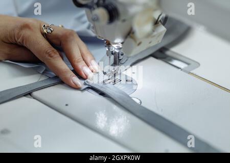 sewing machine scribbling fabric. tailoring at the factory Stock Photo