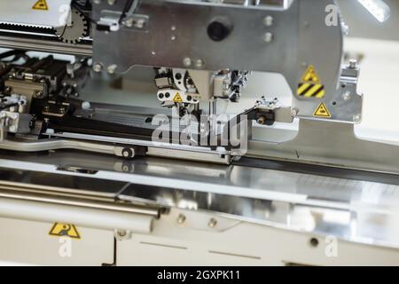 sewing machine scribbling fabric. tailoring at the factory Stock Photo