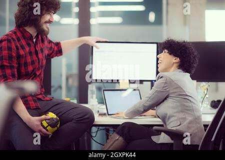 young software developers couple using laptop and desktop computer while writing programming code at modern creative startup office Stock Photo