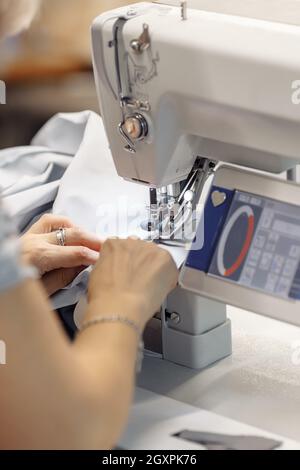 sewing machine scribbling fabric. tailoring at the factory Stock Photo