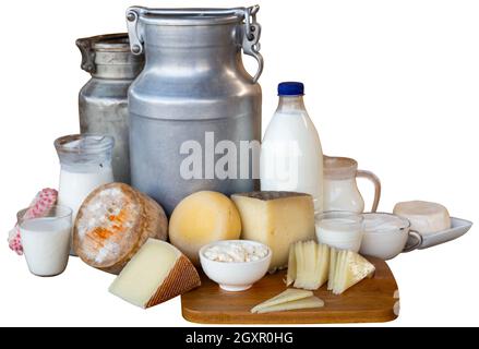 Composition of milk churns and wheels of cheeses on white Stock Photo