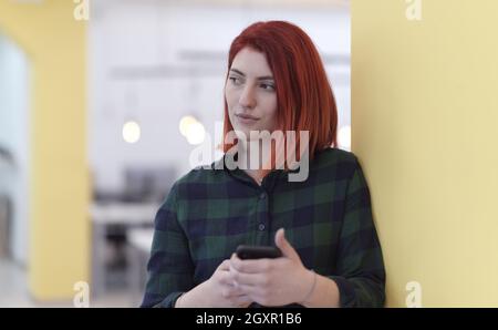 An attractive Female at home among things clothes hanging in