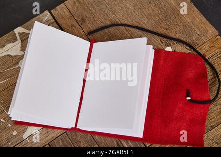Open sketchbook with blank pages and red leather soft cover Stock Photo