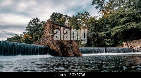 Tranquil speedwell lake park waterfalls in Morristown, NJ with misty motion blur from slow shutter speed Stock Photo