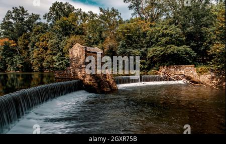 Tranquil speedwell lake park waterfalls in Morristown, NJ with misty motion blur from slow shutter speed Stock Photo