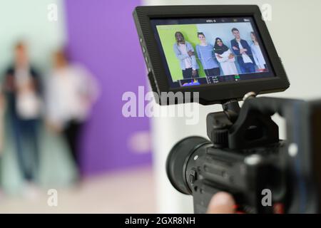 a cameraman with professional equipment shoots video clips in the studio Stock Photo