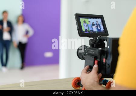 a cameraman with professional equipment shoots video clips in the studio Stock Photo