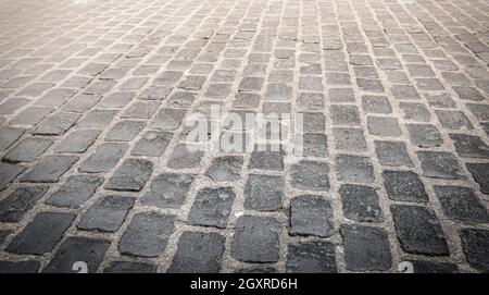 The Granite cobblestoned pavement background. Selective focus Stock Photo