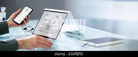Accountant Checking Online Invoice On Tablet Screen Stock Photo