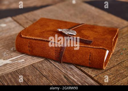 Brown leather journal closed detail on wood boards Stock Photo