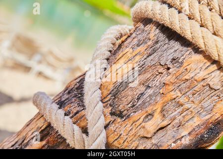 Detail of sailors rope wrapping around wood beam in tropics Stock Photo